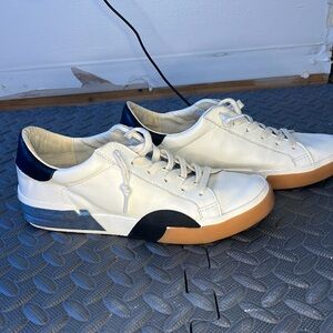 White with black and silver, Dolce Vita tennis shoes. Good condition. Size 7.5